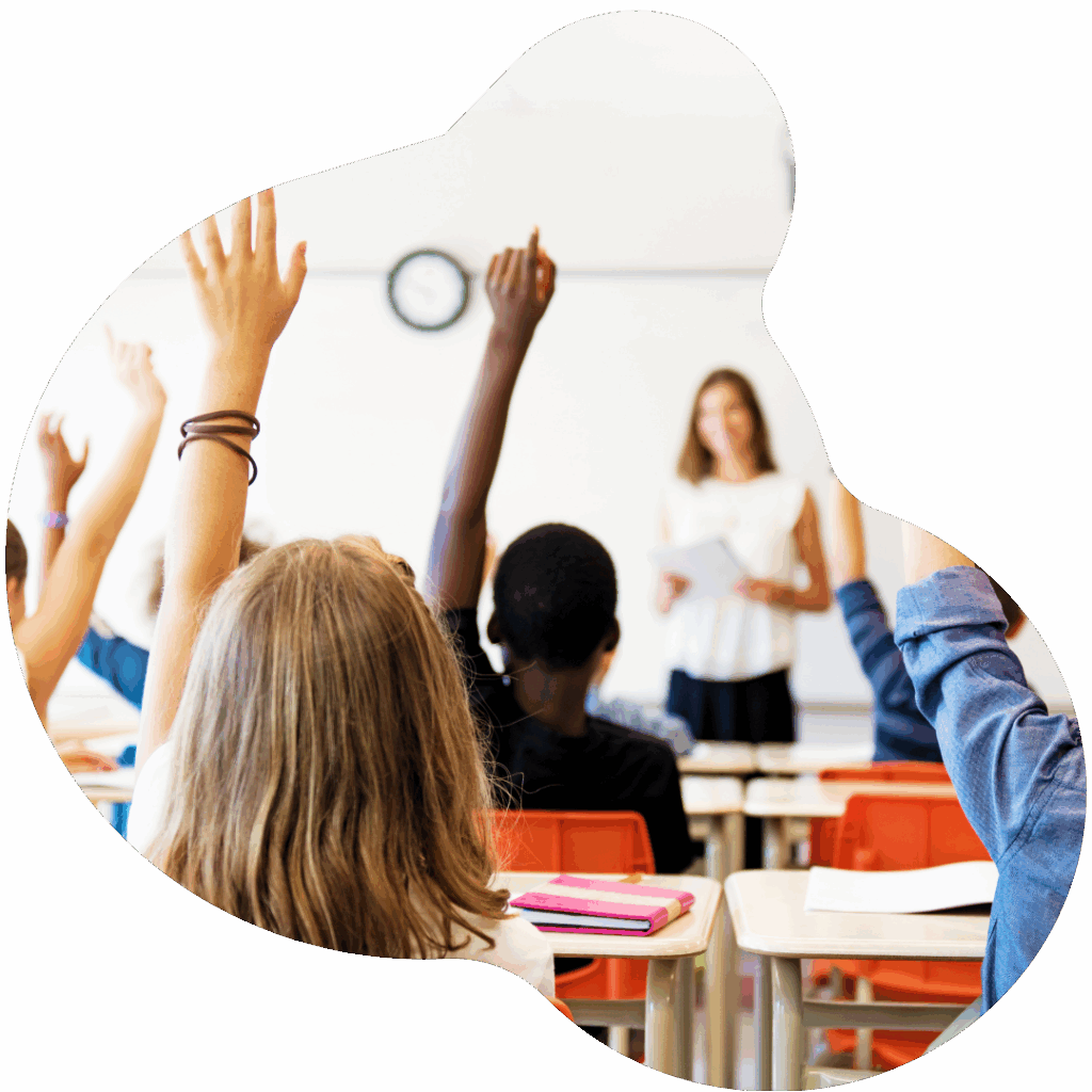 students raising their hands in a classroom