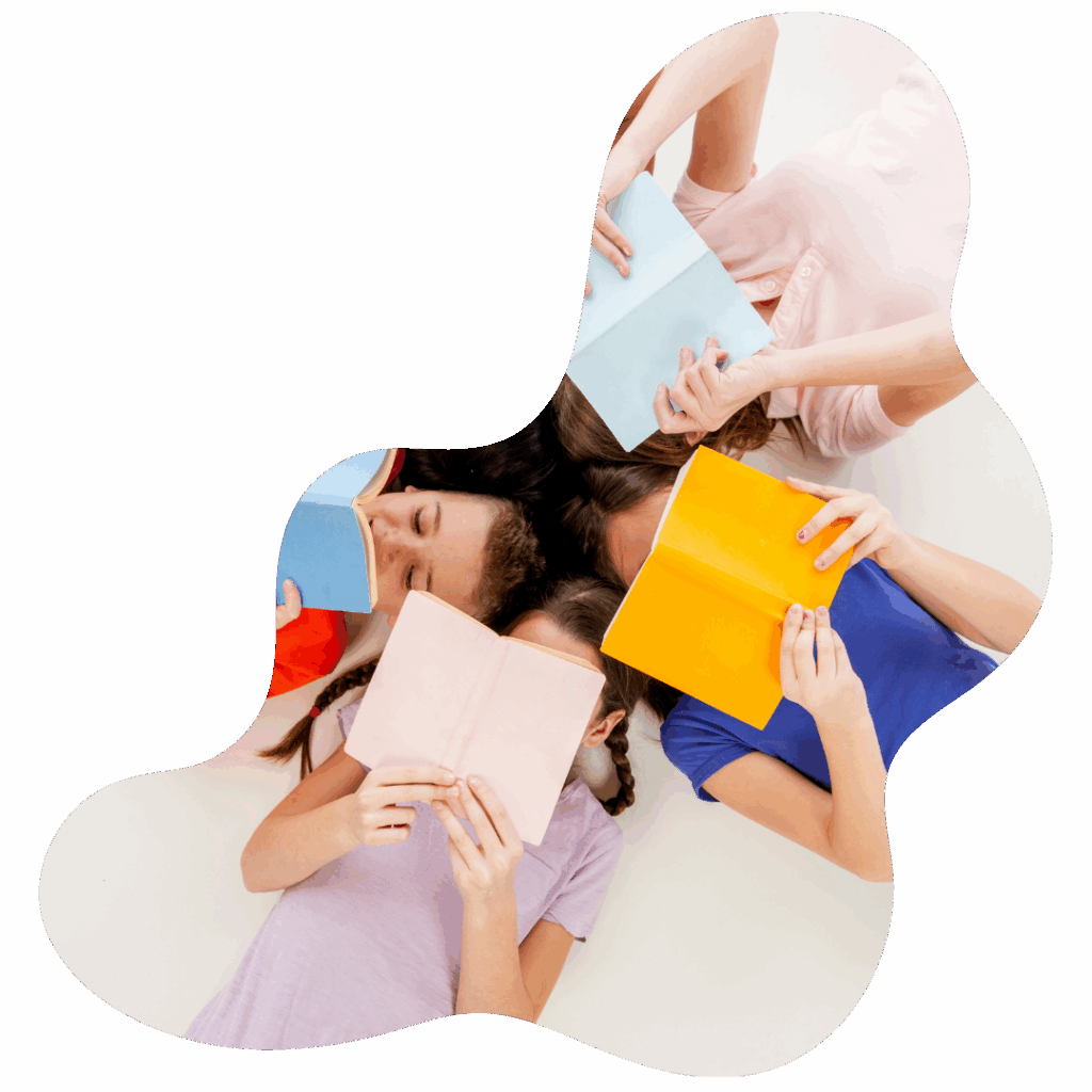 Students laying on the ground reading books