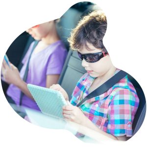 a boy on a car ride using The Juice mobile app to catch up on the news